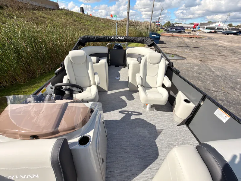 Slide: The Image of The image shows a Sylvan Mirage 822 LZ pontoon boat with luxurious seating and modern design. - 28