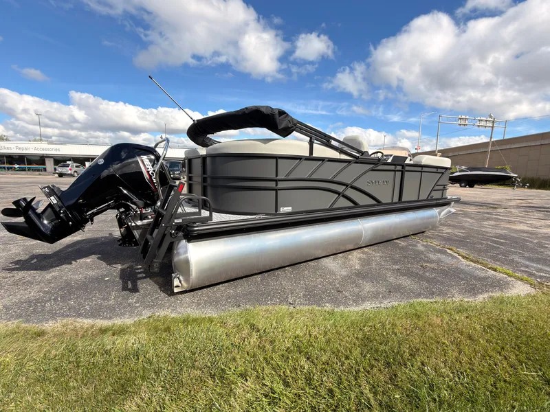 Slide: The Image of A Sylvan Mirage 822 LZ pontoon boat is parked on a lot. It features an outboard motor. - 6