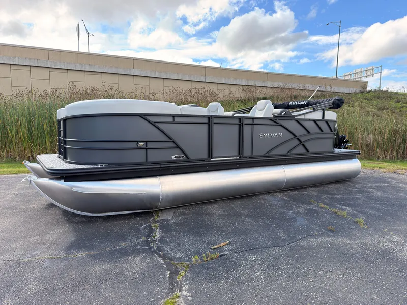 Slide: The Image of The image shows a 2027 Sylvan Mirage 822 LZ pontoon boat parked on a lot. - 2