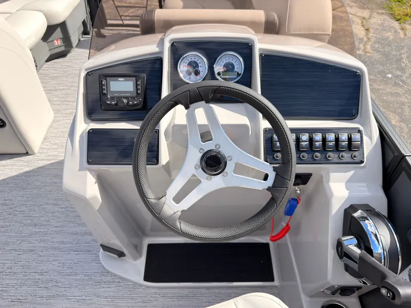 Slide: The Image of The image shows the helm of a 2027 Sylvan Mirage 822 LZ with modern instruments. - 35