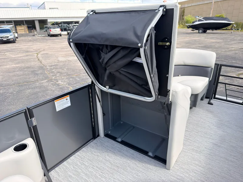 Slide: The Image of The image shows the storage area of a 2027 Sylvan Mirage 822 LZ with gray seating. - 32