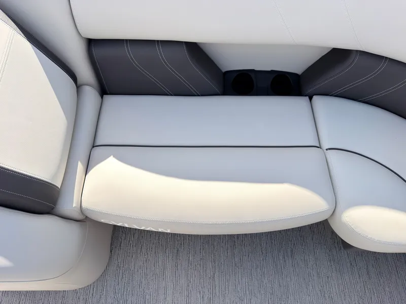 Slide: The Image of The image shows a sleek, cushioned bench seat with gray and white upholstery on a boat. - 48