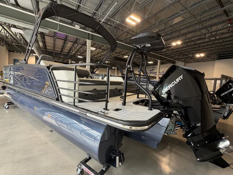 Slide: The Image of A modern Sylvan G-3 ULZ pontoon boat with a Mercury outboard motor in a showroom. - 3