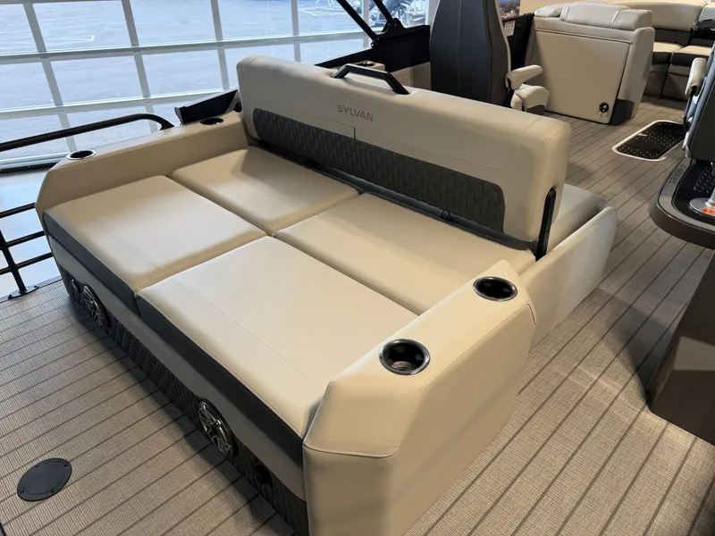 Slide: The Image of The image shows the interior of a 2027 Sylvan G-3 ULZ boat with beige seating. - 34