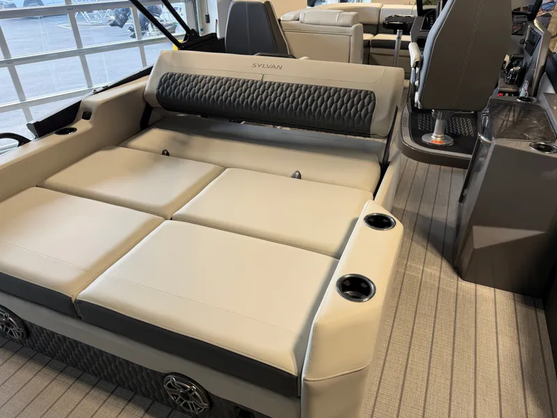 Slide: The Image of The image shows the interior of a 2027 Sylvan G-3 ULZ with beige upholstery and cup holders. - 29