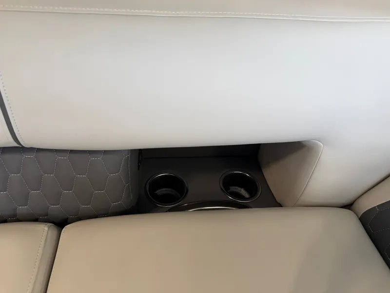 Slide: The Image of Close-up of a boat seat with beige upholstery and two cup holders. - 12