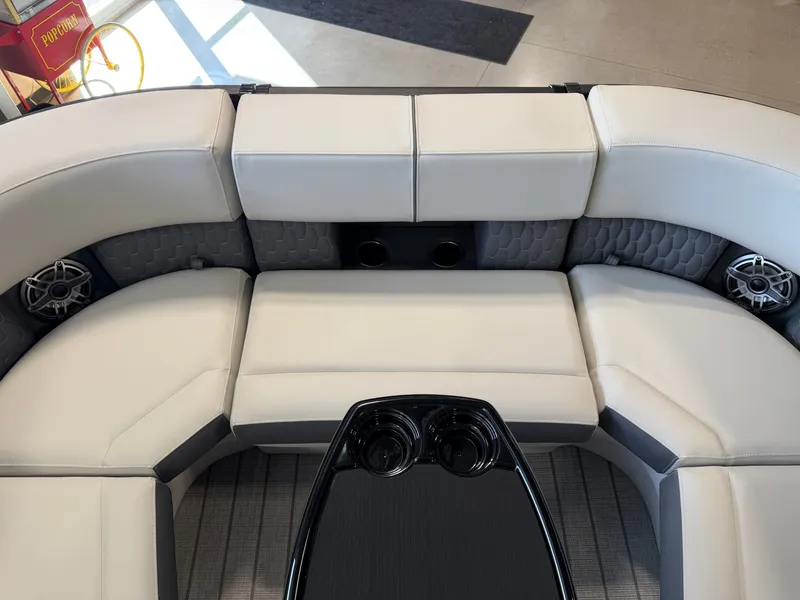 Slide: The Image of The 2027 Sylvan G-3 ULZ features a luxurious white upholstered seating area with built-in speakers. - 9