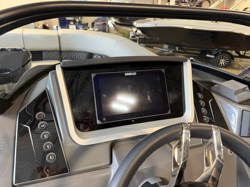 Slide: The Image of The image shows the helm of a Sylvan G-3 ULZ boat with a Simrad display. - 24