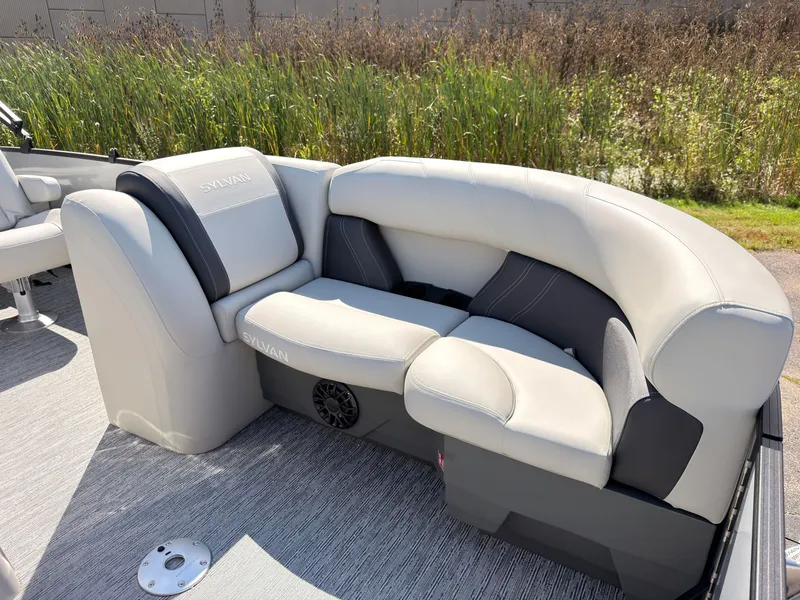 Slide: The Image of The image shows a luxurious seating area on a 2027 Sylvan Mirage 820 CLZ DH boat. - 17
