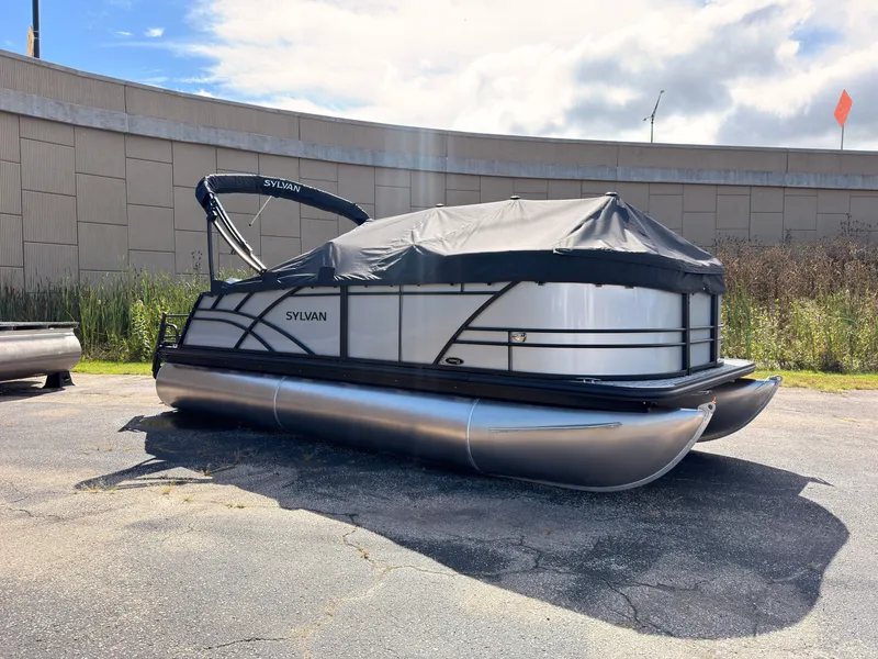 Slide: The Image of A 2027 Sylvan Mirage 820 CLZ DH pontoon boat is parked on a lot. It is covered. - 1