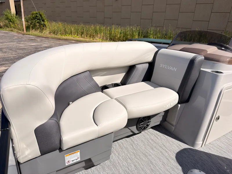 Slide: The Image of The image shows a luxurious, cushioned seating area on a Sylvan Mirage 820 CLZ DH boat. - 11