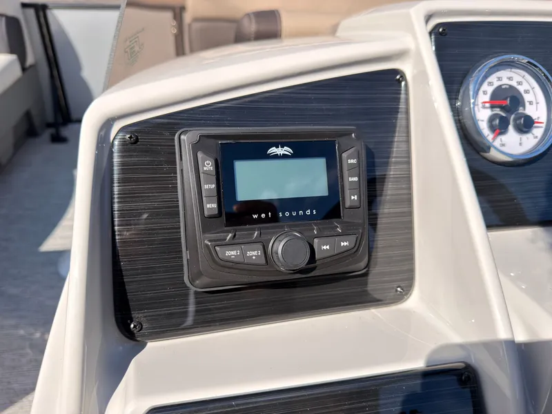Slide: The Image of Close-up of a boat dashboard featuring a Wet Sounds audio system and an analog speedometer. - 34