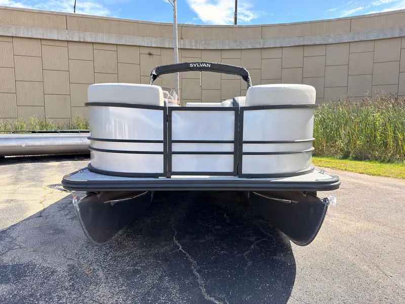 Slide: The Image of A Sylvan Mirage 820 CLZ DH pontoon boat is parked on a lot in front of a building. - 9