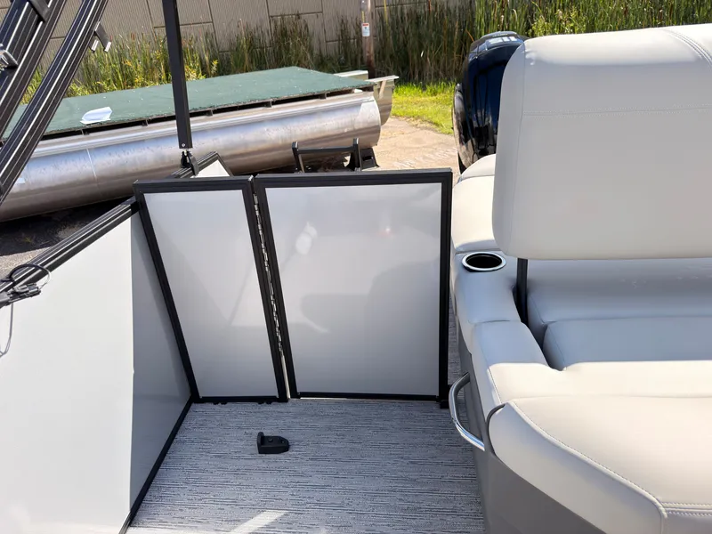 Slide: The Image of The image shows the interior of a 2027 Sylvan Mirage 820 CLZ DH with white leather seats and a cup holder. - 43