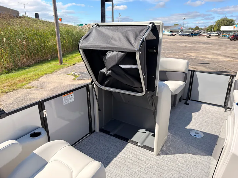 Slide: The Image of The image shows the interior of a 2027 Sylvan Mirage 820 CLZ DH. There are seats and an open storage unit. - 29