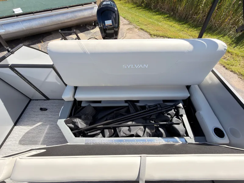 Slide: The Image of The image shows an open bench seat on a Sylvan Mirage 820 CLZ DH boat with storage underneath. - 42