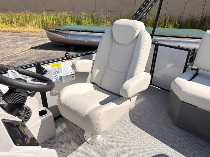Slide: The Image of A luxurious, padded captain's chair on a modern pontoon boat, surrounded by gray carpeting. - 31
