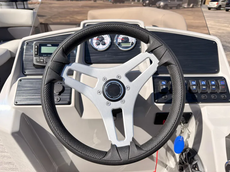 Slide: The Image of The image shows the helm of a 2027 Sylvan Mirage 820 CLZ DH with modern instruments. - 40
