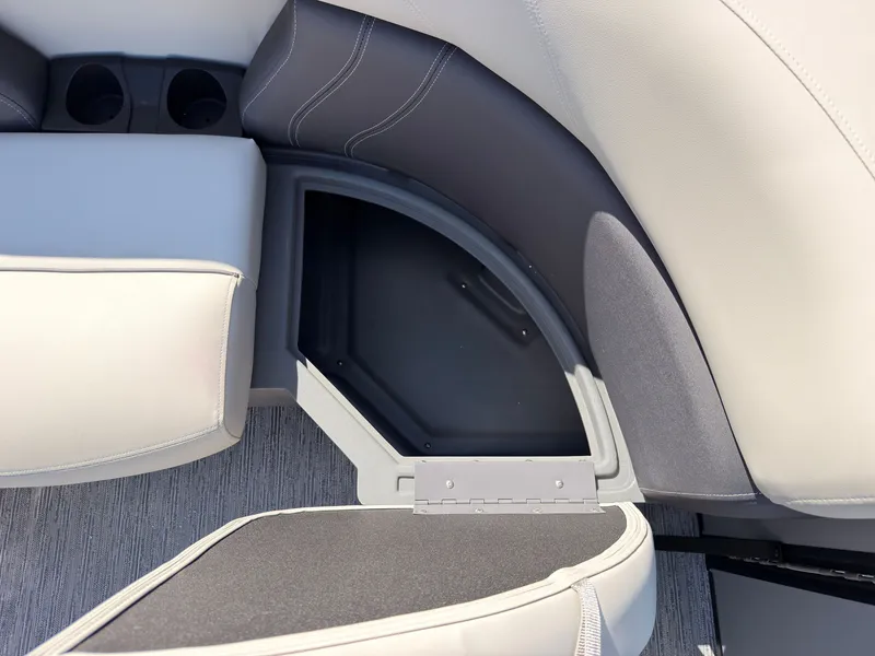 Slide: The Image of The image shows a seating area with storage on a Sylvan Mirage 820 CLZ DH boat. - 19