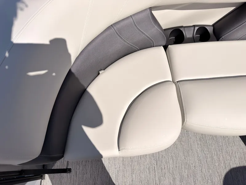 Slide: The Image of The image shows sleek, cream-colored upholstery with gray accents and built-in cup holders. - 12