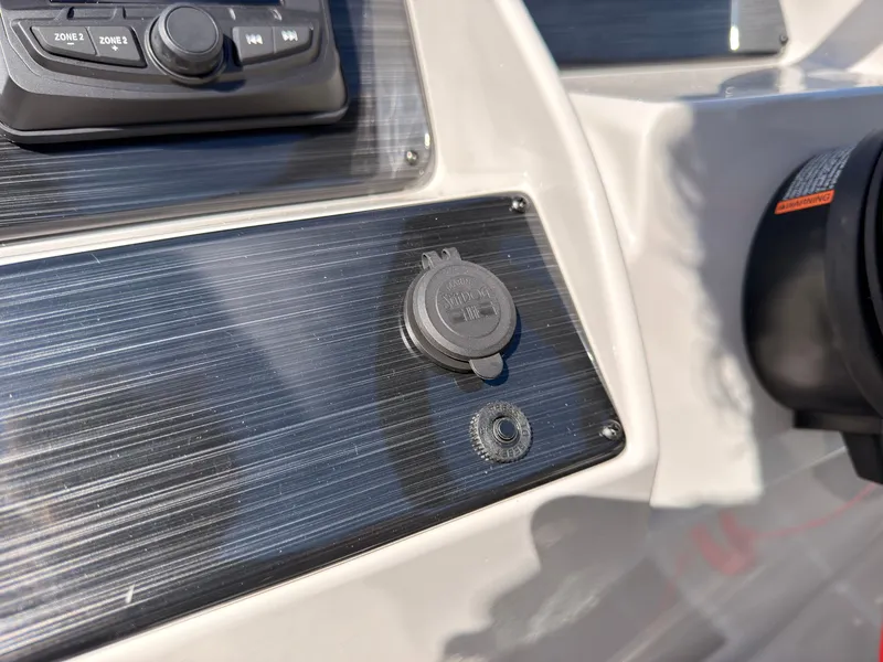 Slide: The Image of Close-up of a boat panel with a power outlet and controls. - 33