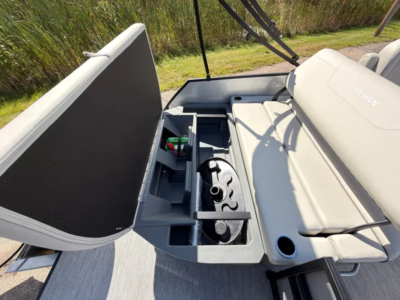 Slide: The Image of The image shows the seating area of a Sylvan Mirage 820 CLZ DH with storage and cup holders. - 46