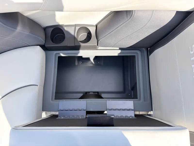 Slide: The Image of The image shows an open storage compartment on a boat with two cup holders beside it. - 15