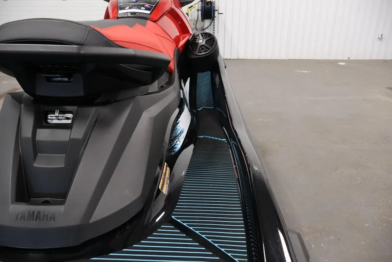 Slide: The Image of 2026 Yamaha WaveRunner VX Deluxe with sleek design and red seat in a garage setting. - 10