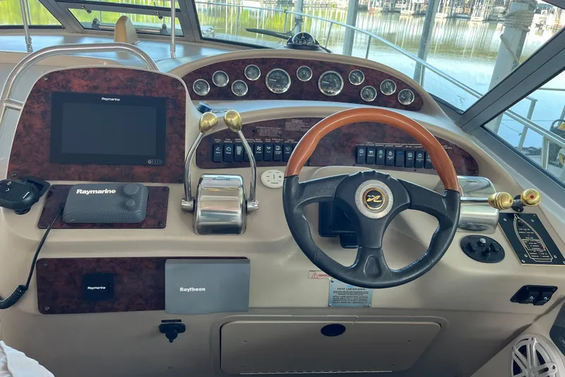 Slide: The Image of Helm of 2001 Sea Ray 340 Sundancer with Raymarine navigation system and wood-accented steering wheel. - 13
