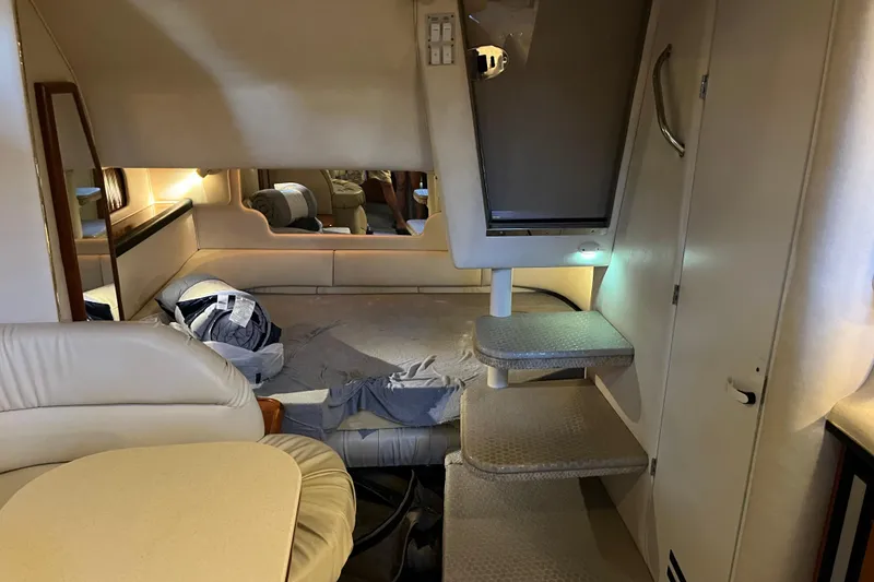 Slide: The Image of Interior of 2001 Sea Ray 340 Sundancer yacht, featuring cozy sleeping area and steps. - 28