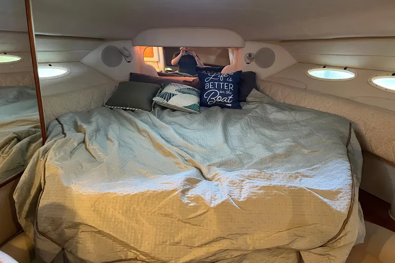 Slide: The Image of Cozy cabin interior of 2001 Sea Ray 340 Sundancer with comfortable bedding and decorative pillows. - 17