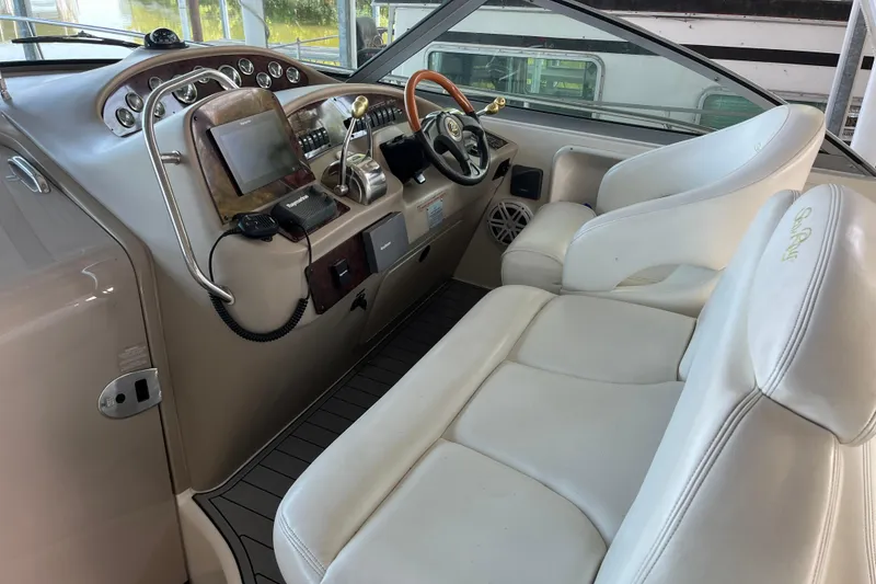 Slide: The Image of 2001 Sea Ray 340 Sundancer helm with white seating and modern controls. - 11