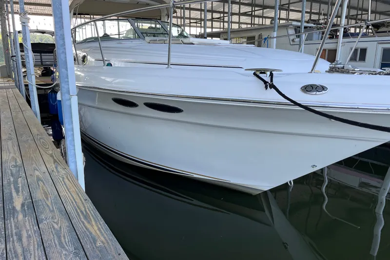 Slide: The Image of 2001 Sea Ray 340 Sundancer docked in a marina, showcasing sleek white hull design. - 1