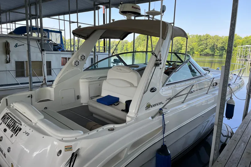 Slide: The Image of 2001 Sea Ray 340 Sundancer docked in a marina, showcasing sleek design and spacious interior. - 40