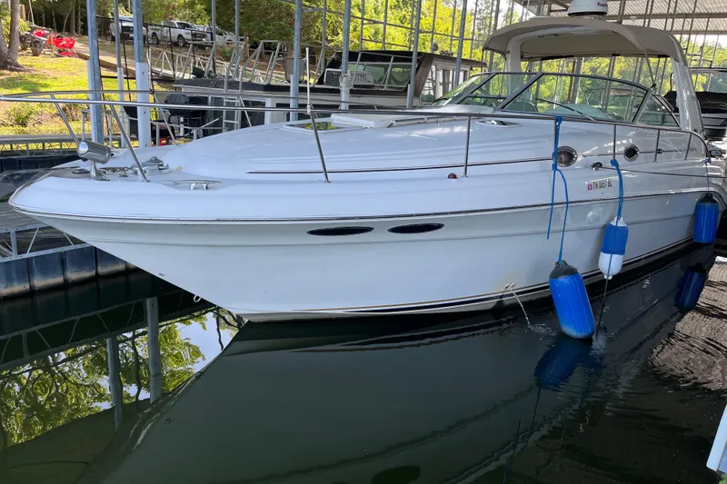 The Image of 2001 Sea Ray 340 Sundancer docked in a marina, featuring sleek white design. - 0