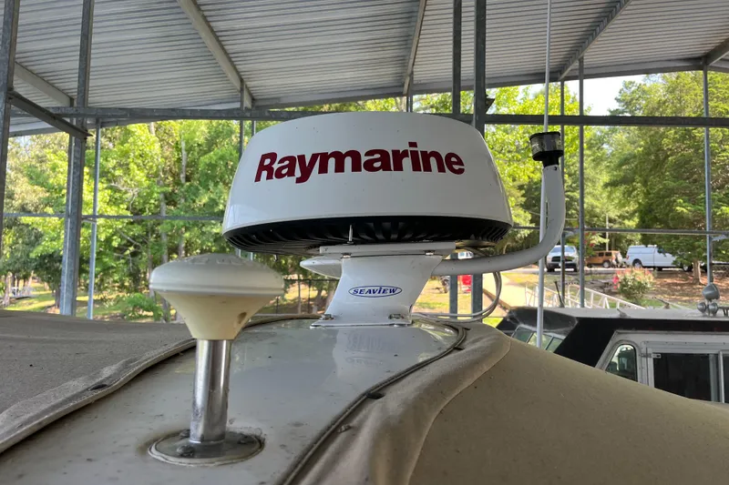 Slide: The Image of Radar equipment on a 2001 Sea Ray 340 Sundancer boat under a metal canopy. - 29