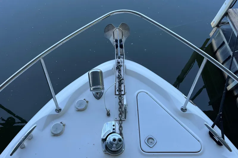 Slide: The Image of Bow of 2001 Sea Ray 340 Sundancer with anchor and railing, docked on calm water. - 36