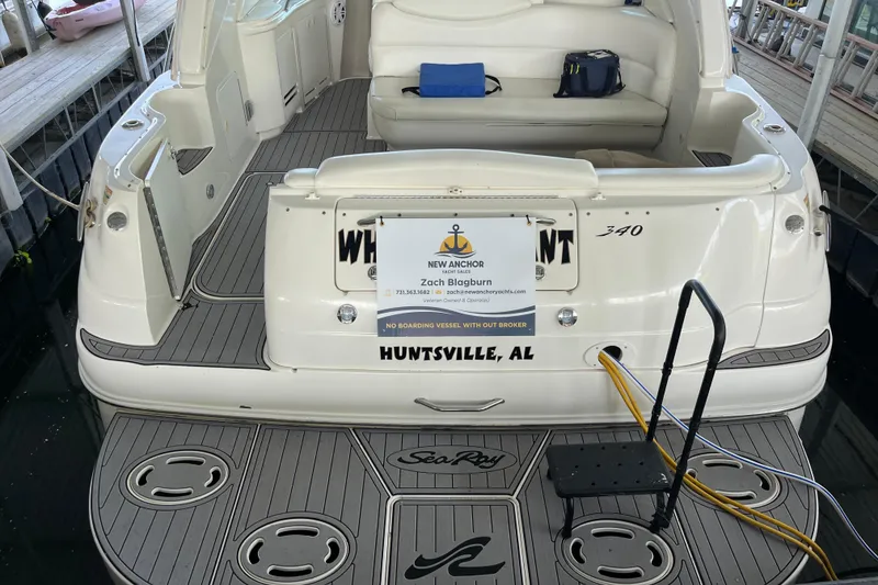 Slide: The Image of 2001 Sea Ray 340 Sundancer docked, featuring spacious seating and elegant design. - 4