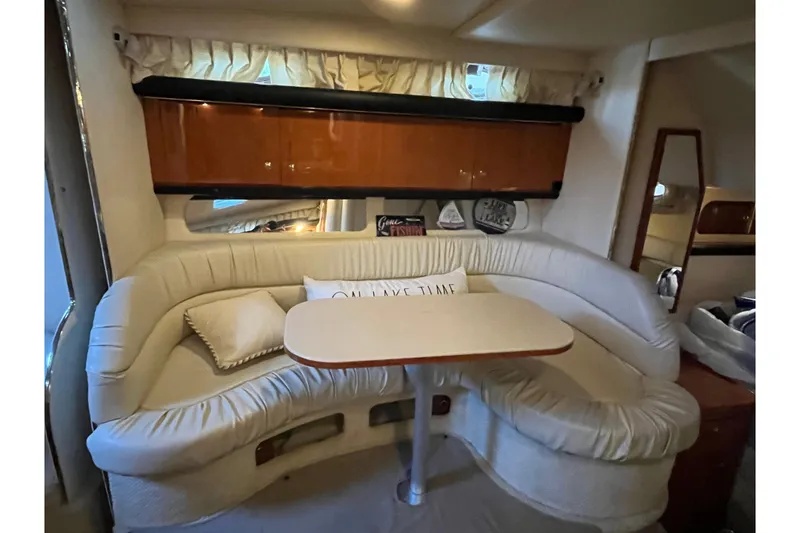 Slide: The Image of Interior of 2001 Sea Ray 340 Sundancer with cozy seating and dining area. - 24