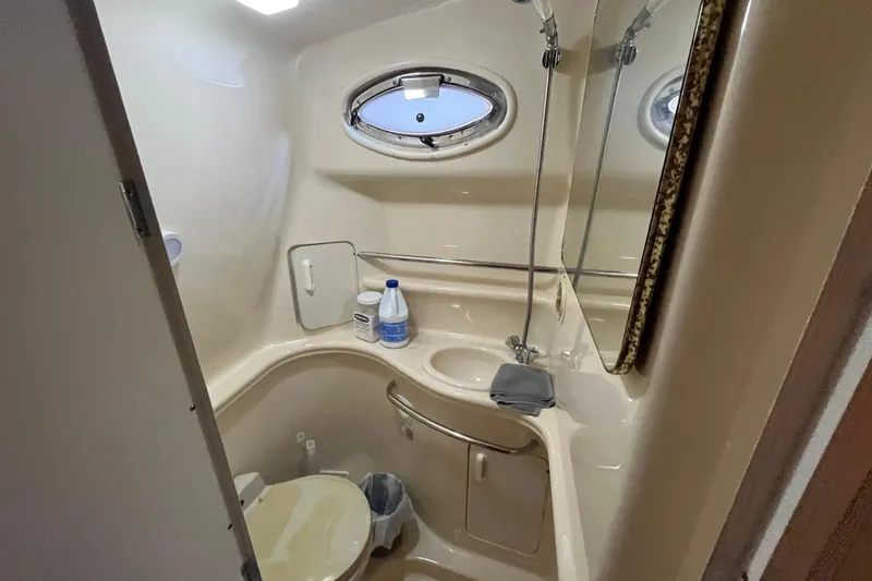Slide: The Image of 2001 Sea Ray 340 Sundancer bathroom with sink, toilet, and mirror. - 25