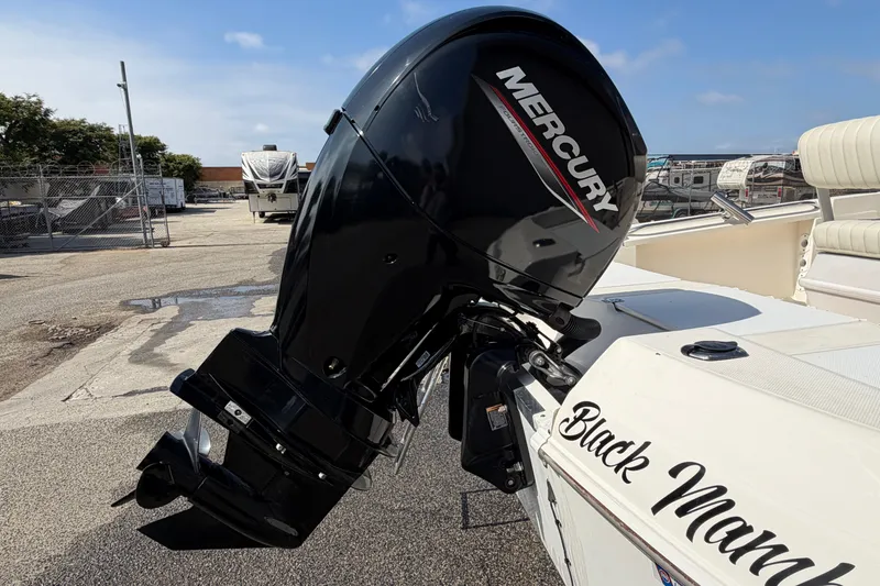 Slide: The Image of 2005 Wellcraft 200 LT Fisherman boat with Mercury outboard motor, docked outdoors. - 10