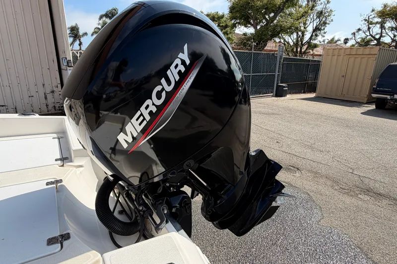 Slide: The Image of Mercury outboard motor on a 2005 Wellcraft 200 LT Fisherman boat, parked outdoors. - 12