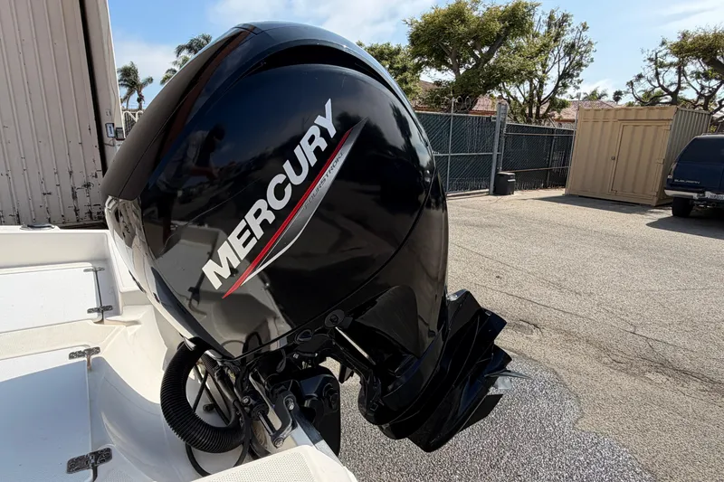 Slide: The Image of 2005 Wellcraft 200 LT Fisherman with Mercury outboard motor in a parking area. - 27