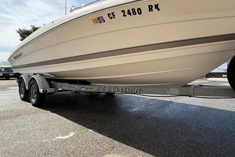 Slide: The Image of 2005 Wellcraft 200 LT Fisherman boat on EZ Loader trailer, parked on asphalt. - 28