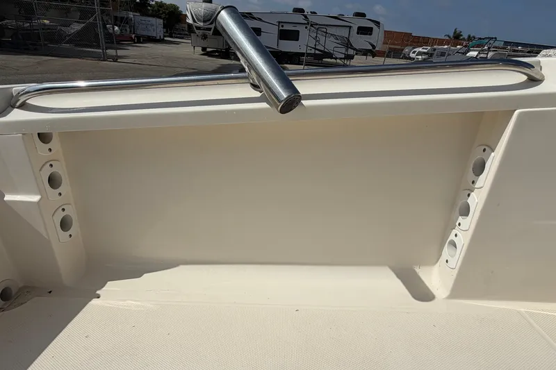 Slide: The Image of 2005 Wellcraft 200 LT Fisherman boat interior with rod holders and railing. - 16