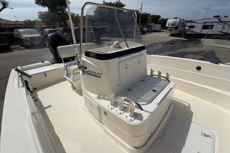 Slide: The Image of 2005 Wellcraft 200 LT Fisherman boat with center console and seating, parked outdoors. - 24