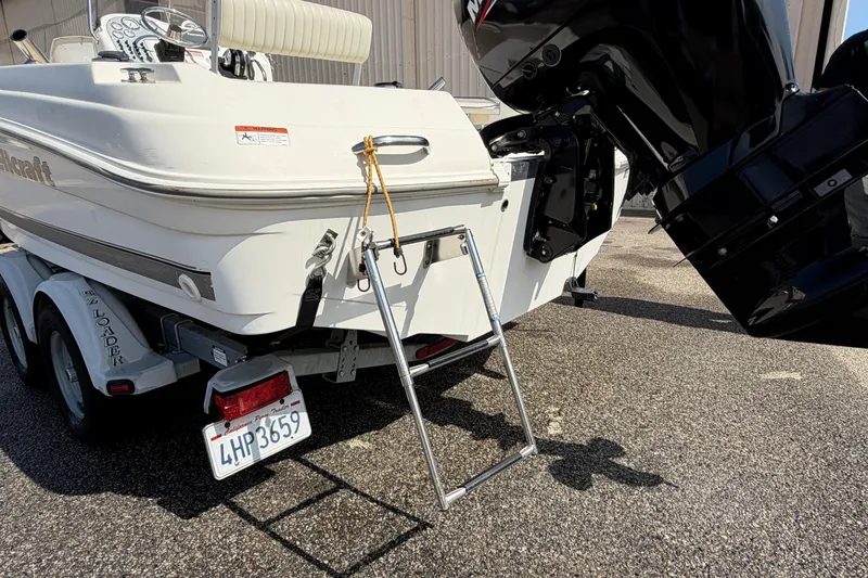 Slide: The Image of 2005 Wellcraft 200 LT Fisherman boat on trailer with outboard motor and ladder. - 13