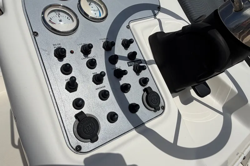 Slide: The Image of Control panel of a 2005 Wellcraft 200 LT Fisherman boat with gauges and switches. - 26