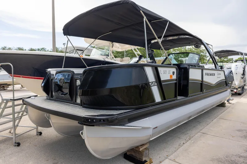 Slide: The Image of 2026 Premier 270 Intrigue GTS RF - CL pontoon boat with port gate, docked outdoors. - 2