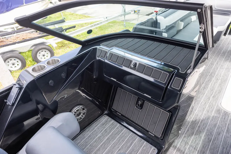 Slide: The Image of Interior of 2026 Premier 270 Intrigue GTS RF boat with sleek black dashboard and seating. - 9